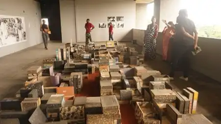 Ndidi Dike, A History of a City in a Box, installation view with guests, Lagos Biennial 2019